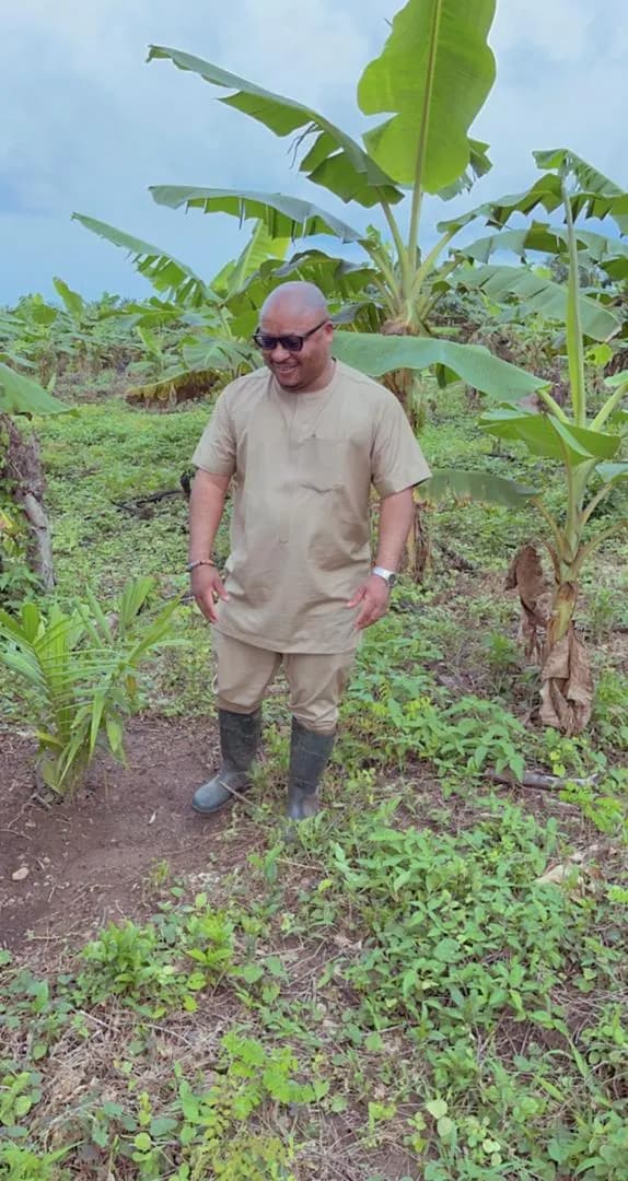 Dr. Rasheed Olayinka Alausa walking through a farm