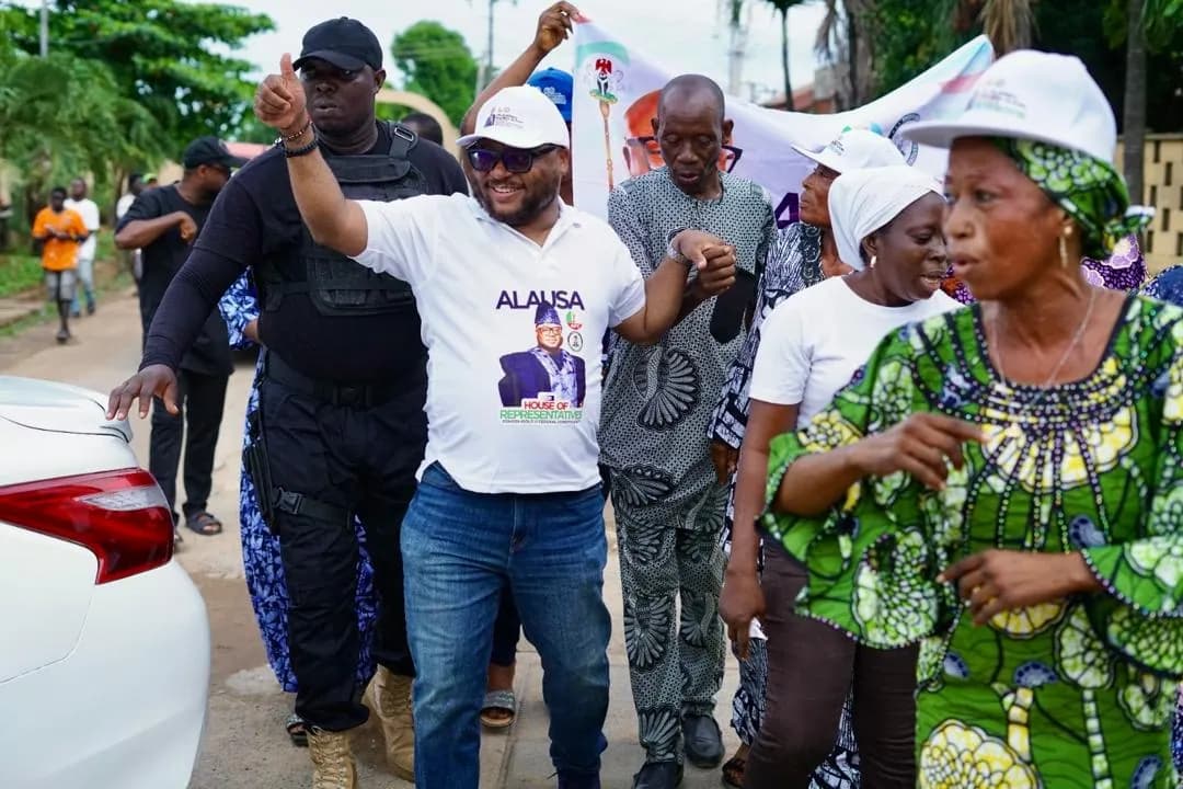 Dr. Rasheed Olayinka Alausa walking with supporters during a constituency visit